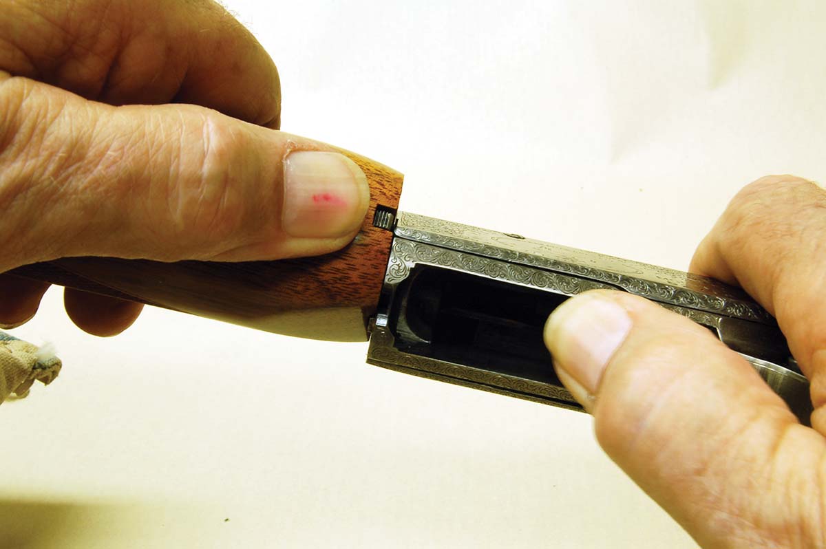 The barrel is removed by pushing the takedown button in, pulling back the breechblock and turning the barrel counterclockwise.